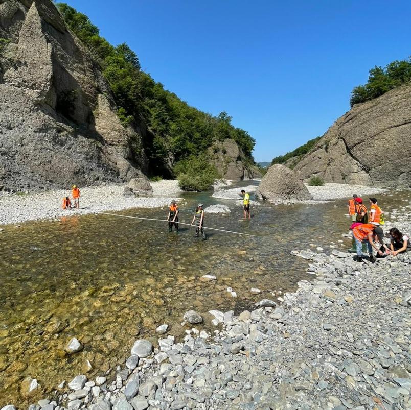 Studenti in uscita didattica che eseguono una misura di portata di un fiume