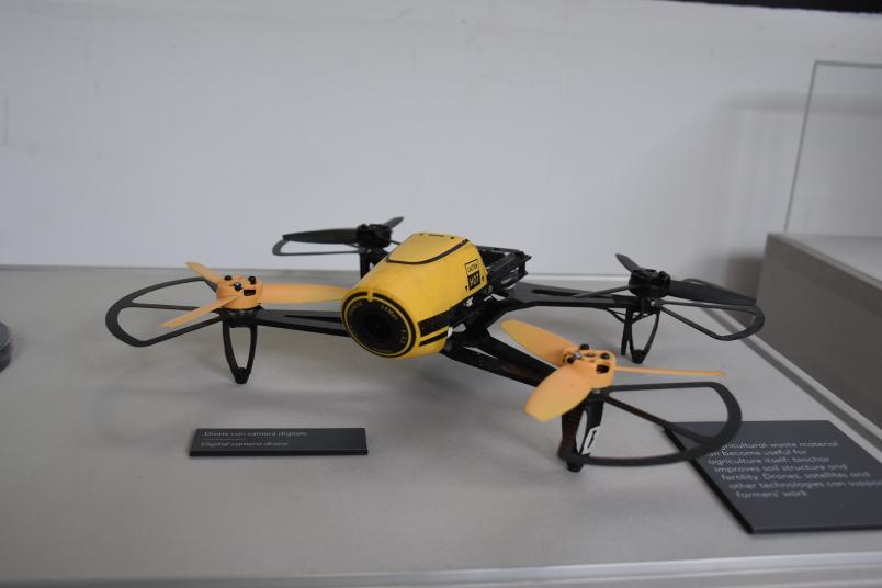 Yellow drone with four propellers and a digital camera